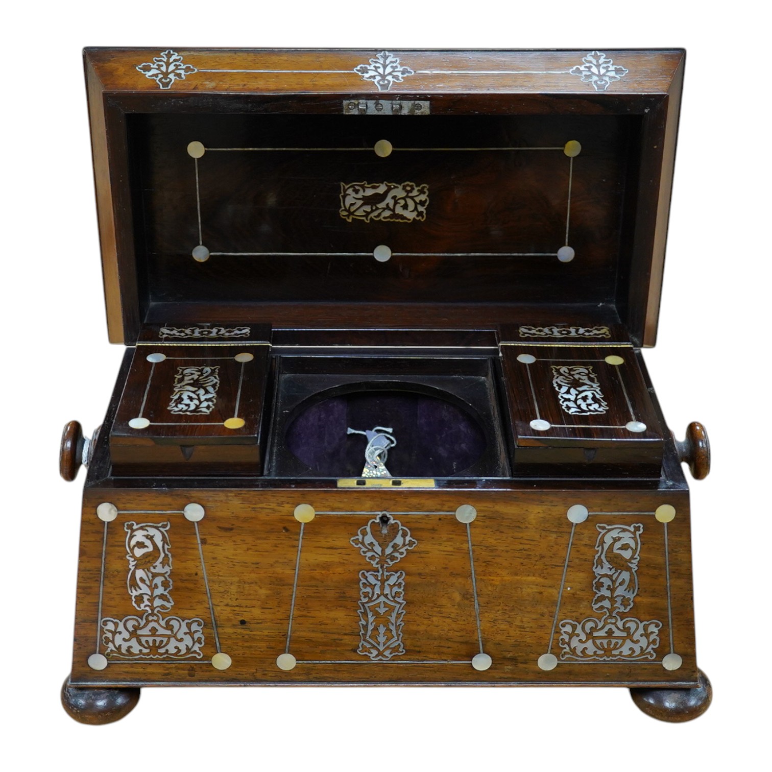 A Victorian rosewood and mother-of-pearl inlaid sarcophagus tea caddy, 39cm wide. Condition - fair
